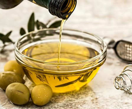 If olives are botanically classified as a fruit, can we say that olive oil is fruit juice? While we may not consume olive oil in the same way that we do apple or orange juice, there’s a reason people have used it for centuries. It’s popular for cooking, as a skin moisturizer, to strengthen hair, and even as a remedy for sore throats and wounds. You might think this “green gold” is a much less healthy counterpart to your morning fruit juice. However, olive oil has been shown to provide many health benefits if you consume it regularly. Health benefits of olive oil Olive oil has various health benefits. The majority of the fats in olive oil are made up of monounsaturated fatty acids (MUFAs). These have been shown to increase levels of “good” cholesterol (HDL) while lowering “bad” cholesterol (LDL). Out of all plant-based cooking oils, olive oil has the highest levels of MUFAs. This, along with the anti-inflammatory and antioxidant compounds in olive oil, may reduce plaque buildup in your arteries. It may also help protect your body from harmful chemicals that have been linked to chronic diseases like cancer, autoimmune diseases, and heart disease. Types of olive oils While olive oil has many great benefits, it’s worth noting that different types of olive oils vary in nutritional quality. This is because they have different amounts of beneficial compounds like polyphenols (compounds with anti-inflammatory and antioxidant characteristics) and other antioxidants. Extra virgin olive oil (EVOO) contains the highest percentage of polyphenols and antioxidants. That’s because it goes through a single processing procedure whereas other types are processed more. More processing causes more polyphenols and antioxidants to be lost. Virgin olive oil (VOO) is only slightly more processed than EVOO. It still contains most of the olives’ polyphenolic and antioxidant compounds but not as many as EVOO. VOO is also milder in flavor. Finally, “light,” “pure,” and refined olive oils are more moderately processed. This leads to the mildest flavor, meaning they contain much less of the beneficial compounds. Recommended oil intake The daily recommended intake for oil varies depending on age, sex, and activity level. The 2020-2025 Dietary Guidelines for Americans recommends 27 grams (just under 2 tablespoons) of any type of added oils per day for a 2,000 calorie diet. Ways to add olive oil into your diet Here are some ideas for adding olive oil – to replace other types of fats – into your diet so you can reap its benefits: Use it as a salad dressing: Mix together olive oil, balsamic vinegar and mustard for a simple and delicious salad dressing. Drizzle it over roasted vegetables: Toss your favorite veggies with a bit of olive oil and roast them in the oven for a healthy side dish. Use it for cooking: Olive oil may be used for cooking. The more refined types of olive oil may be heated to a higher temperature than EVOO, though EVOO may be used at lower cooking temperatures. If you want to maintain the integrity of the flavor and quality of the olive oil, use your higher quality EVOO as a finishing oil.